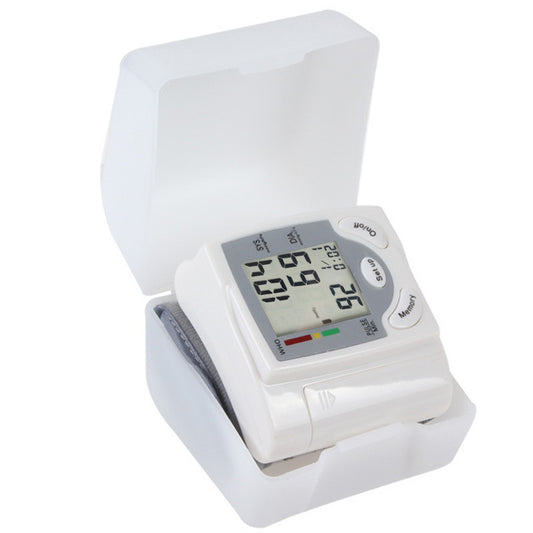 Blood pressure monitor with digital display on a white background