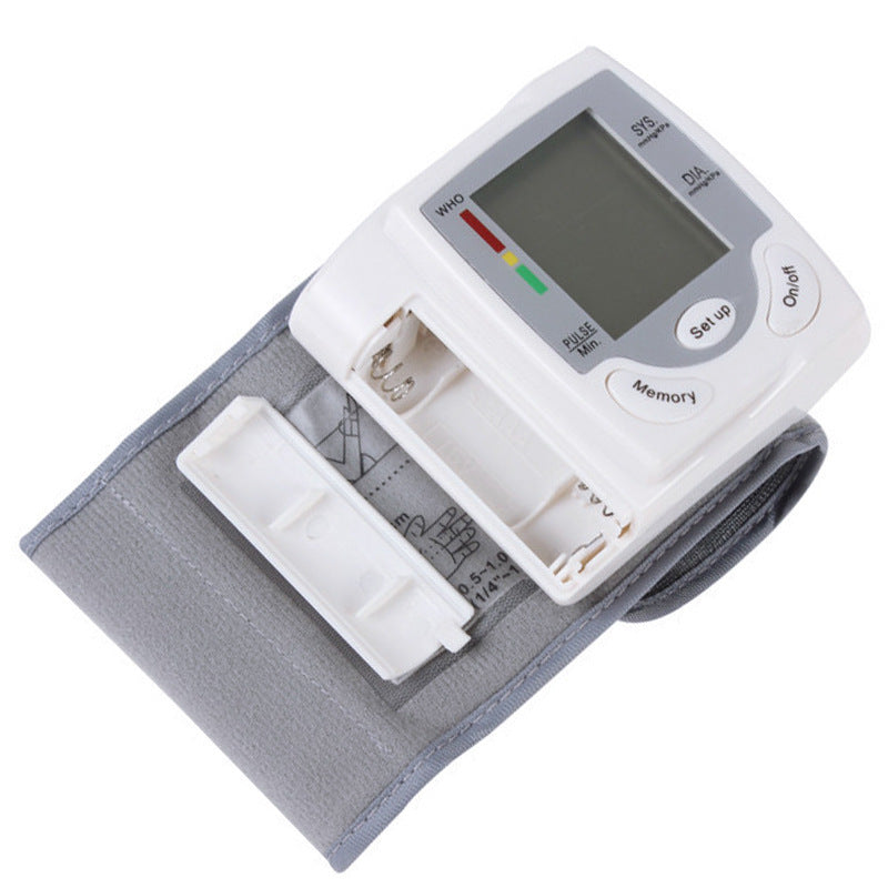 Blood pressure monitor with digital display on a white background