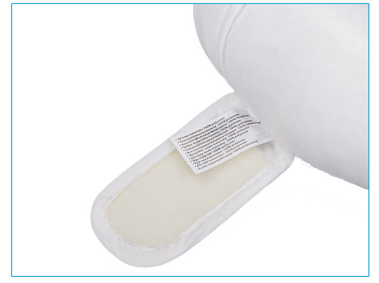 Close-up of a white Baby Head-Shaped Banana Pillow with a label on a white background