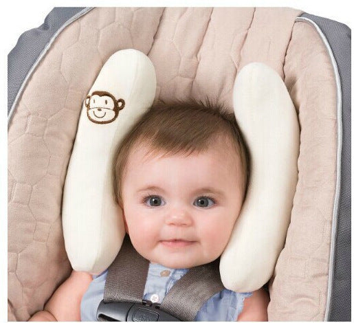 Baby in a car seat with a Baby Head-Shaped Banana Pillow.