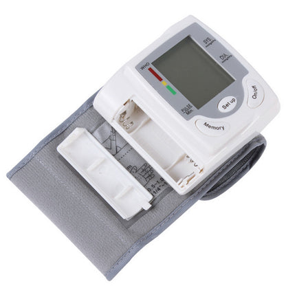 Blood pressure monitor with digital display on a white background