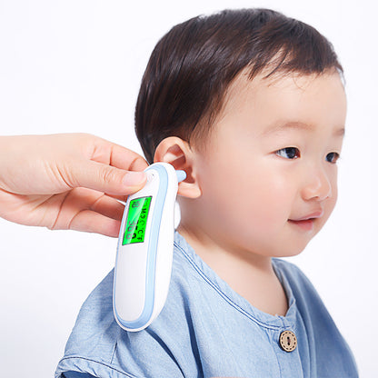 Child having their ear checked with a digital thermometer on a white background
