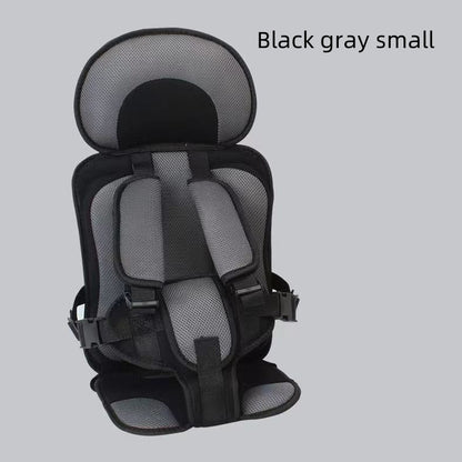 Black and gray child safety seat on a light gray background