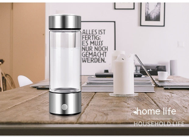HydraPure™ Hydrogen Water Bottle with silver base on a wooden table, with 'home life' branding.