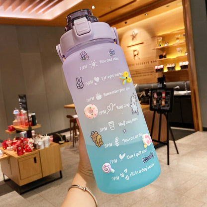 HydraTrack™ 2L Water Bottle with cartoon designs held in a casual setting